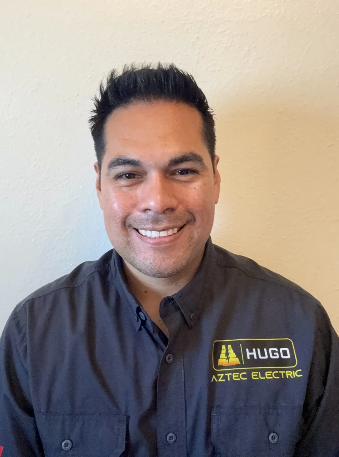 Hugo, owner and electrician at Aztec Electric LLC, in uniform