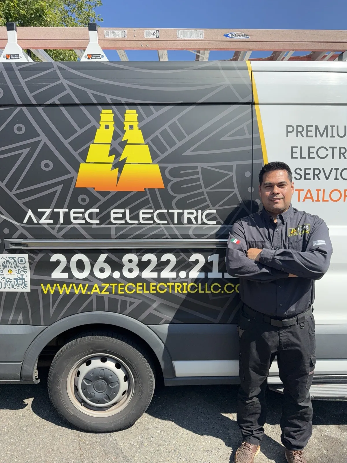 Hugo standing beside the Aztec Electric service van